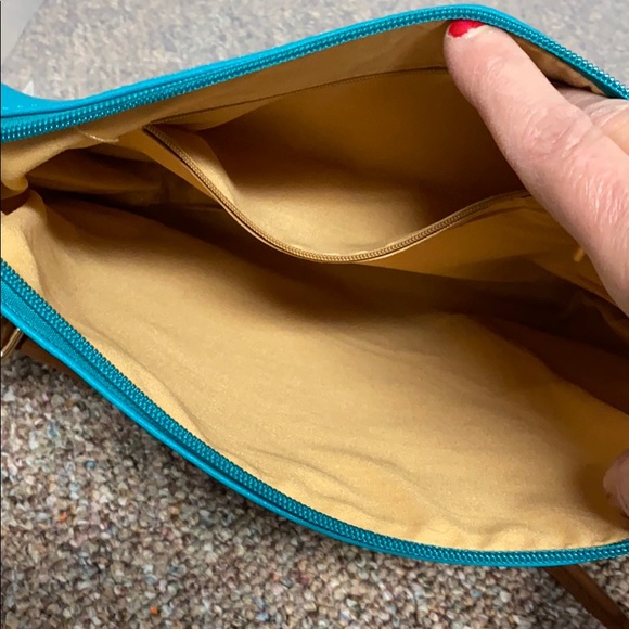 Turquoise crossbody bag with brown handles. - Picture 2 of 3